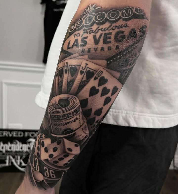 Black and grey Las Vegas gambling sleeve tattoo with cards, dice and roulette by Independence Ink.