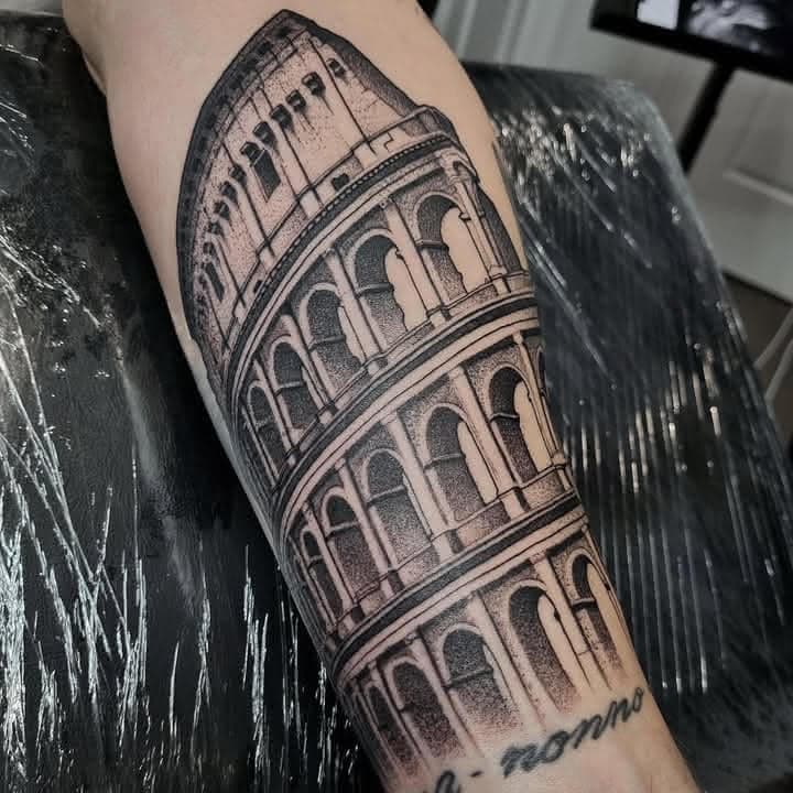 Detailed black and grey Roman Colosseum architecture tattoo by Independence Ink.