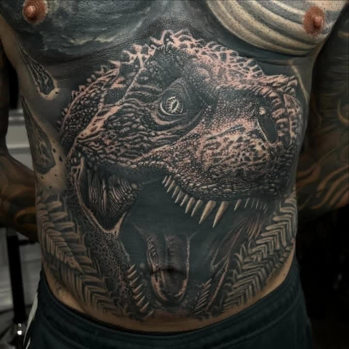 Black and grey realism Tyrannosaurus rex chest tattoo by Independence Ink.