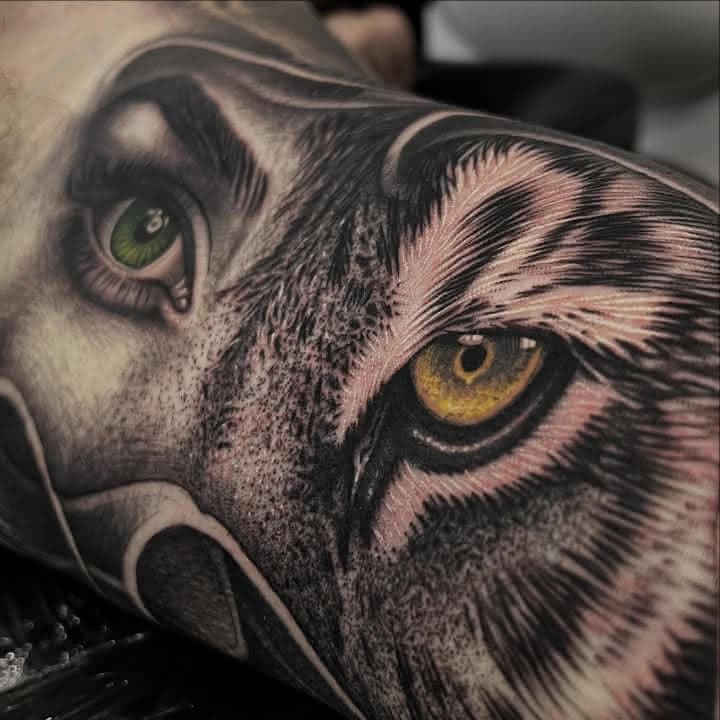 Split-face colour realism tattoo combining a woman and tiger by Independence Ink.