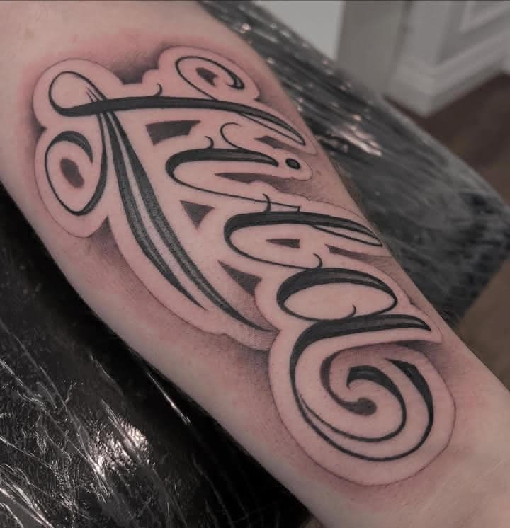 Custom black script lettering tattoo by Independence Ink in Camden.